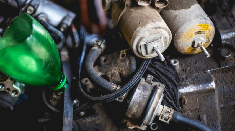 a close up of a car engine with a green light