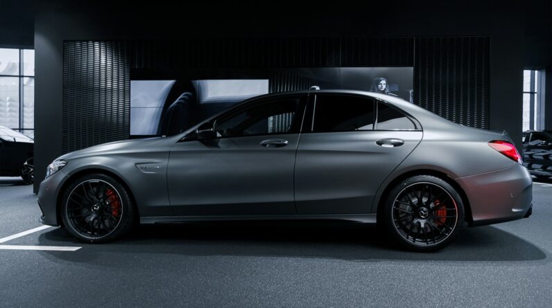 black coupe in a dark room