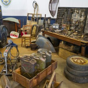 a room with old vehicles and tools