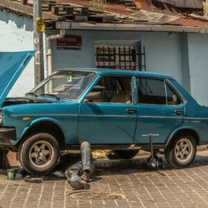 a blue car parked in front of a blue building