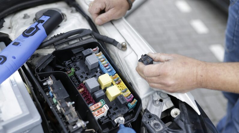 a man is working on a car's engine